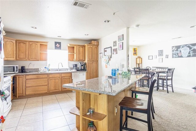 14752 Grafton Ln, Helendale, CA 92342 - kitchen with open shelves, a kitchen breakfast bar, stainless steel microwave, and a sink