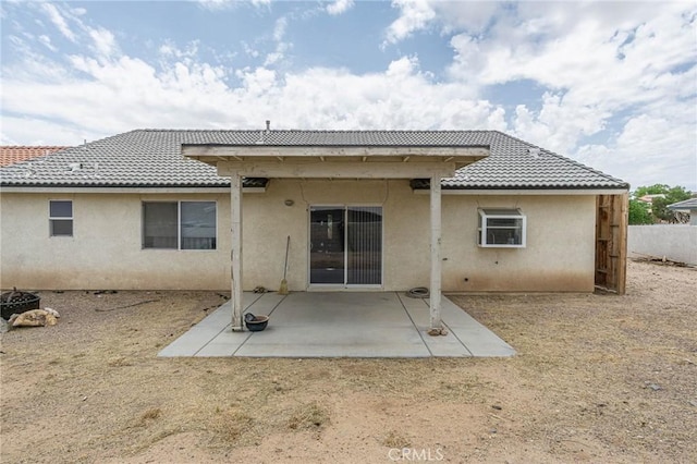 14752 Grafton Ln, Helendale, CA 92342 - back of property featuring stucco siding, a patio area, and a tile roof
