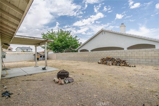 14752 Grafton Ln, Helendale, CA 92342 - fenced backyard featuring an outdoor fire pit and a patio