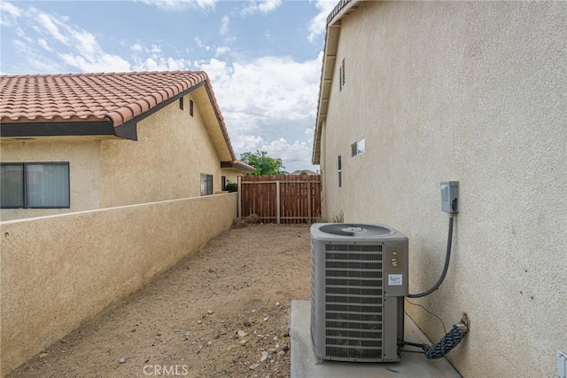 14752 Grafton Ln, Helendale, CA 92342 - view of side of home featuring cooling unit, stucco siding, and a tiled roof