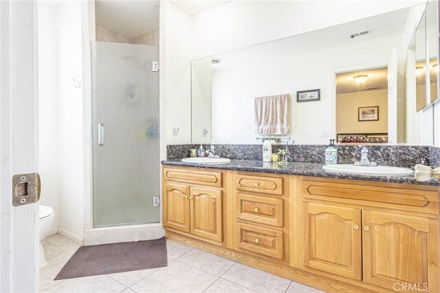 14752 Grafton Ln, Helendale, CA 92342 - bathroom featuring tile patterned floors, a stall shower, double vanity, and toilet