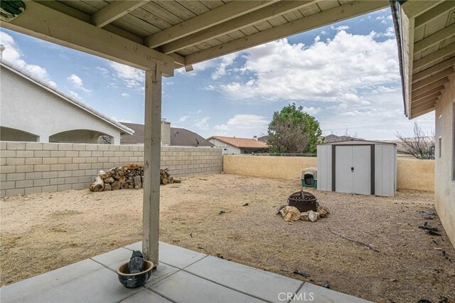 14752 Grafton Ln, Helendale, CA 92342 - fenced backyard with a patio and an outdoor fire pit