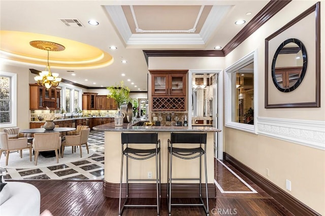1539 Rodeo Rd, Arcadia, CA 91006 - bar area featuring a raised ceiling, crown molding, decorative backsplash, hanging light fixtures, and recessed lighting