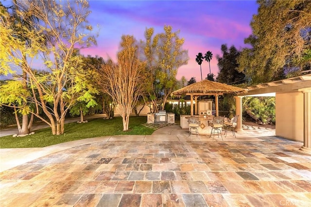 1539 Rodeo Rd, Arcadia, CA 91006 - patio terrace at dusk featuring a gazebo, an outdoor kitchen, a patio, and a yard