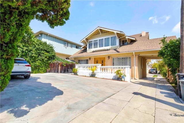 1610 N Hobart Blvd, Los Angeles, CA 90027 - view of front of home with driveway, a shingled roof, a chimney, and a porch