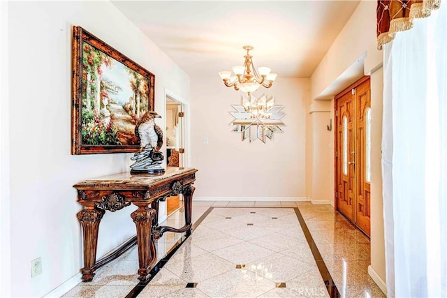 1610 N Hobart Blvd, Los Angeles, CA 90027 - entrance foyer with inlaid floor details, baseboards, and a chandelier