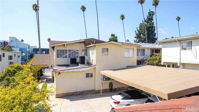 1610 N Hobart Blvd, Los Angeles, CA 90027 - rear view of house featuring stucco siding and central air condition unit