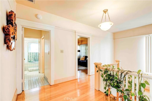 1610 N Hobart Blvd, Los Angeles, CA 90027 - corridor with light wood-style floors, baseboards, and an upstairs landing