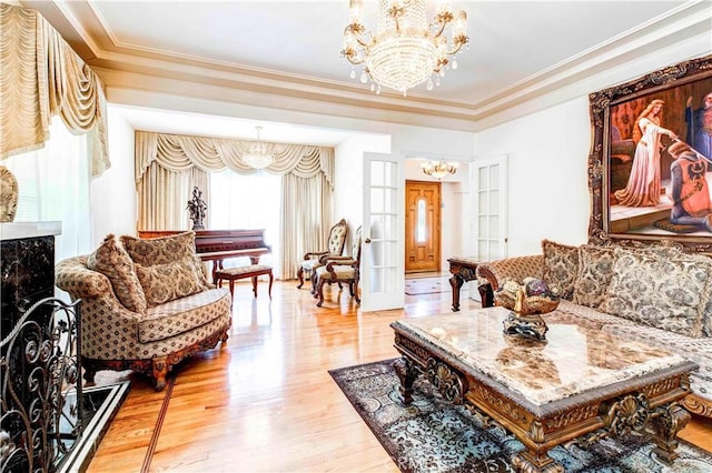 1610 N Hobart Blvd, Los Angeles, CA 90027 - living room featuring a chandelier, wood finished floors, ornamental molding, a tray ceiling, and a high end fireplace
