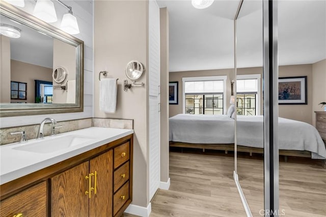 13219 Wimberly Sq Unit 306, San Diego, CA 92128 - ensuite bathroom featuring vanity, wood finished floors, and baseboards