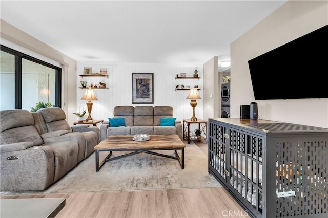 13219 Wimberly Sq Unit 306, San Diego, CA 92128 - living room with stacked washer / drying machine and light wood-style floors