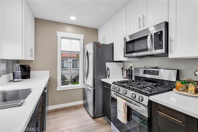 13219 Wimberly Sq Unit 306, San Diego, CA 92128 - kitchen with stainless steel appliances, white cabinetry, light countertops, light wood-type flooring, and recessed lighting