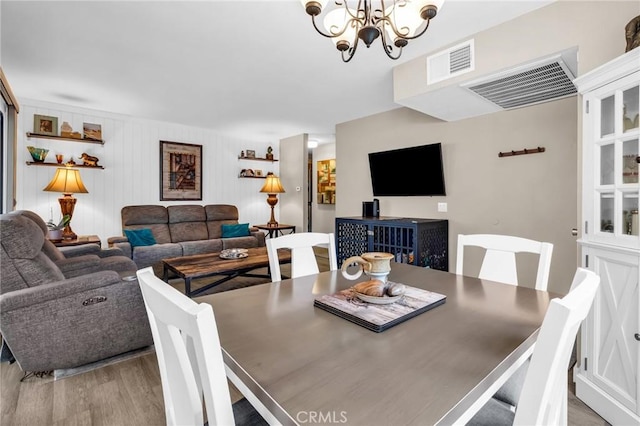 13219 Wimberly Sq Unit 306, San Diego, CA 92128 - dining room featuring wood finished floors and a chandelier