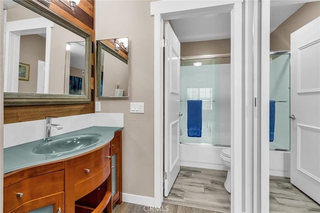 13219 Wimberly Sq Unit 306, San Diego, CA 92128 - full bathroom featuring vanity, shower / bath combination with glass door, toilet, and baseboards