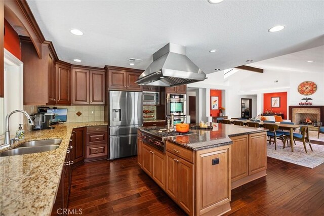 27121 Shenandoah Dr, Laguna Hills, CA 92653 - kitchen featuring stainless steel appliances, island range hood, dark wood-style flooring, light stone countertops, and vaulted ceiling