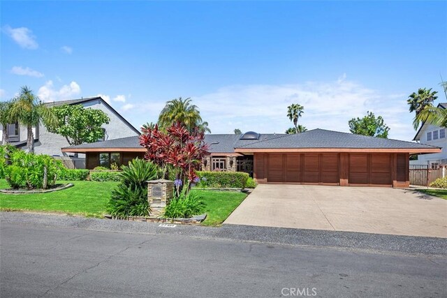 27121 Shenandoah Dr, Laguna Hills, CA 92653 - view of front of house with an attached garage, driveway, and a front yard