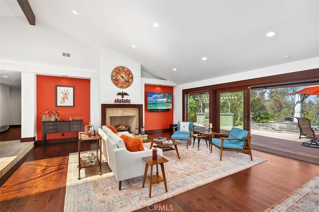 27121 Shenandoah Dr, Laguna Hills, CA 92653 - living area featuring a warm lit fireplace, healthy amount of natural light, high vaulted ceiling, wood-type flooring, and recessed lighting