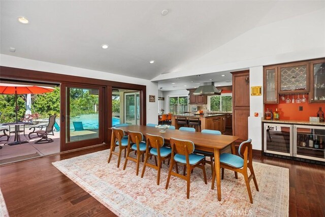 27121 Shenandoah Dr, Laguna Hills, CA 92653 - dining room featuring vaulted ceiling, a dry bar, wine cooler, plenty of natural light, and dark wood finished floors