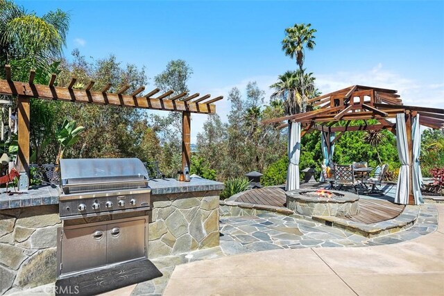 27121 Shenandoah Dr, Laguna Hills, CA 92653 - view of patio with an outdoor fire pit, an outdoor kitchen, and a pergola