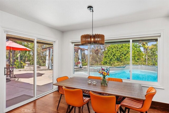 27121 Shenandoah Dr, Laguna Hills, CA 92653 - dining area with wood finished floors, plenty of natural light, and a chandelier