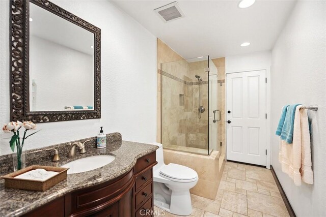 27121 Shenandoah Dr, Laguna Hills, CA 92653 - full bathroom featuring stone tile flooring, tiled shower, vanity, and recessed lighting