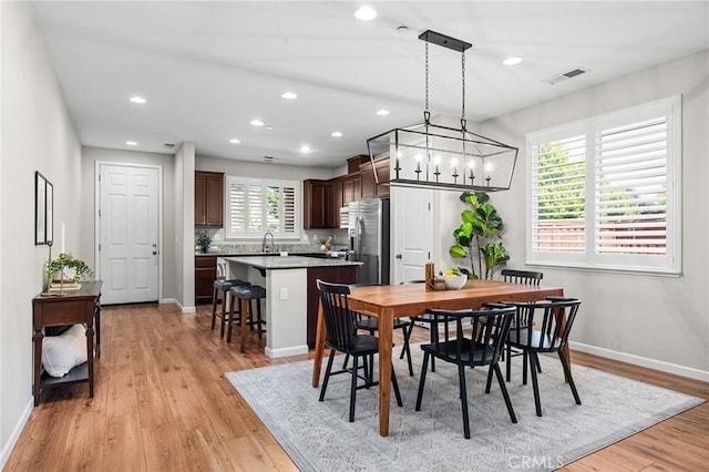 3274 Tinker Creek Way, Chico, CA 95973 - dining area with baseboards, light wood-style floors, recessed lighting, and a chandelier
