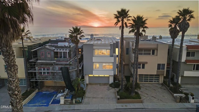 815 Mandalay Beach Rd, Oxnard, CA 93035 - view of building exterior featuring a water view, a garage, and driveway