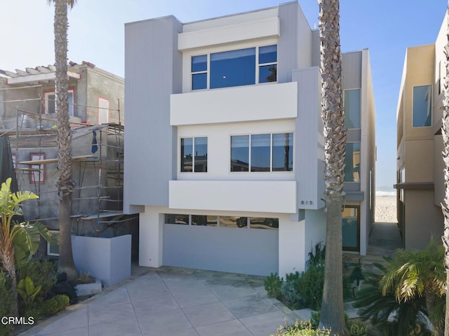 815 Mandalay Beach Rd, Oxnard, CA 93035 - contemporary home featuring a garage, stucco siding, and driveway