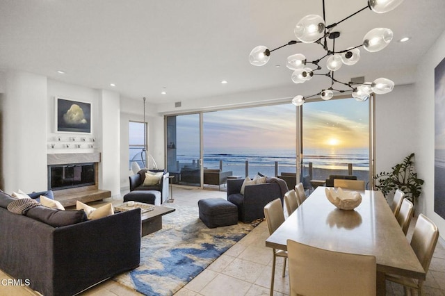815 Mandalay Beach Rd, Oxnard, CA 93035 - living area with a chandelier, a premium fireplace, a water view, recessed lighting, and tile patterned flooring
