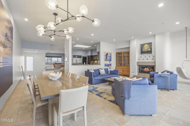 815 Mandalay Beach Rd, Oxnard, CA 93035 - dining room featuring a glass covered fireplace, recessed lighting, a chandelier, and light tile patterned floors