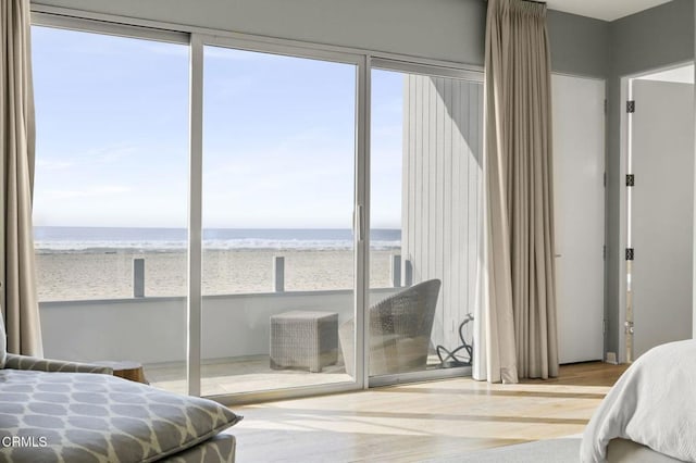 815 Mandalay Beach Rd, Oxnard, CA 93035 - bedroom featuring view of water and beach, multiple windows, and wood finished floors