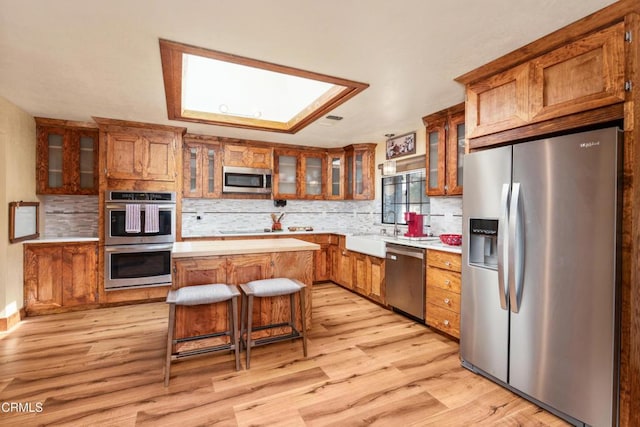 51793 Quail Ridge Rd, Oakhurst, CA 93644 - kitchen featuring stainless steel appliances, light countertops, and brown cabinetry