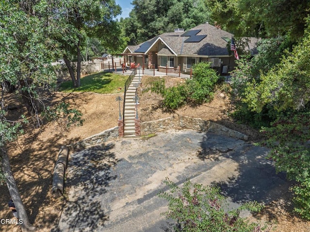 51793 Quail Ridge Rd, Oakhurst, CA 93644 - view of front of home featuring solar panels, stairs, and a porch