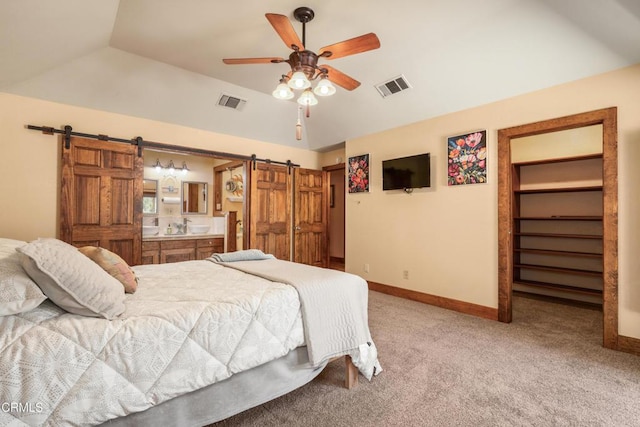 51793 Quail Ridge Rd, Oakhurst, CA 93644 - bedroom featuring a barn door, lofted ceiling, light colored carpet, baseboards, and ceiling fan