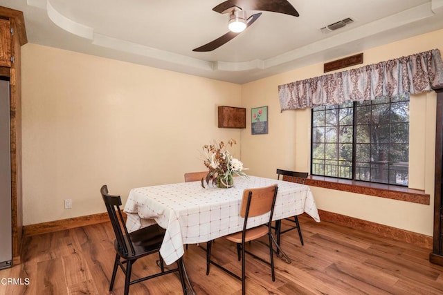 51793 Quail Ridge Rd, Oakhurst, CA 93644 - dining space featuring a ceiling fan, baseboards, wood finished floors, and a tray ceiling