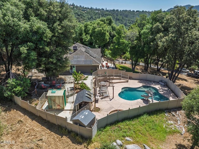 51793 Quail Ridge Rd, Oakhurst, CA 93644 - view of swimming pool with a fenced backyard, a wooded view, and a patio