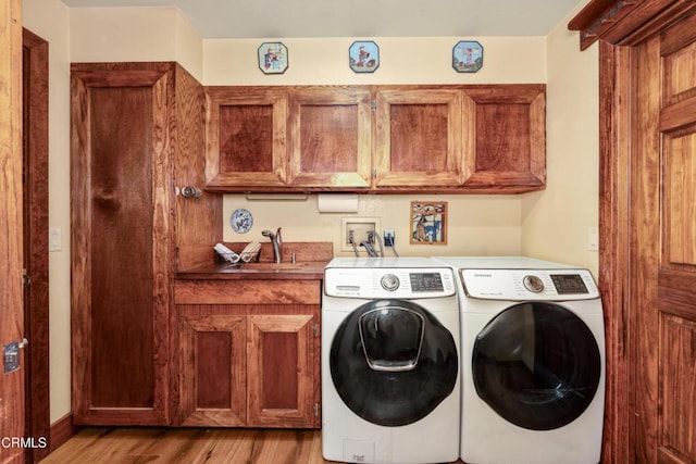 51793 Quail Ridge Rd, Oakhurst, CA 93644 - laundry room featuring cabinet space, washing machine and dryer, and light wood-type flooring