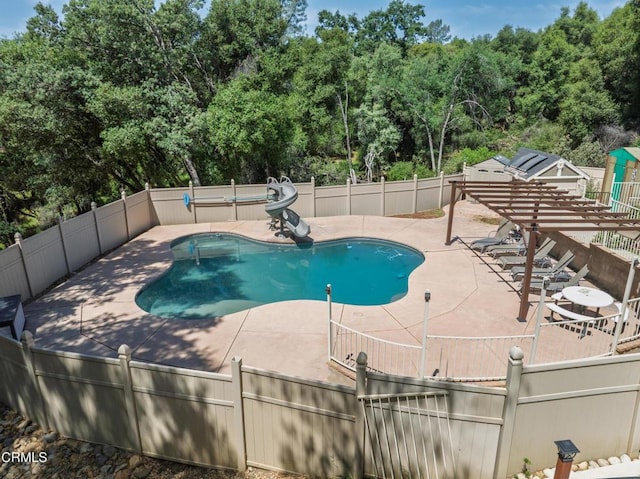 51793 Quail Ridge Rd, Oakhurst, CA 93644 - view of pool with a water slide, a patio area, and view of wooded area