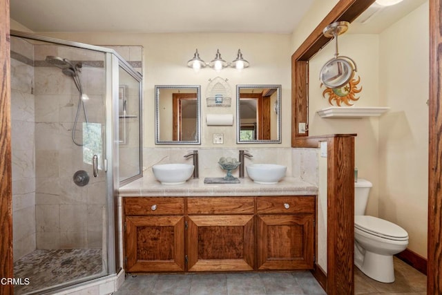 51793 Quail Ridge Rd, Oakhurst, CA 93644 - bathroom featuring double vanity, a shower stall, toilet, decorative backsplash, and tile patterned floors
