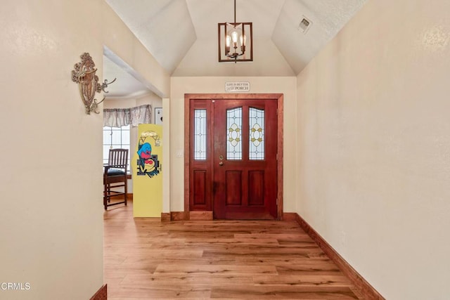 51793 Quail Ridge Rd, Oakhurst, CA 93644 - entryway featuring wood finished floors, a chandelier, baseboards, and lofted ceiling