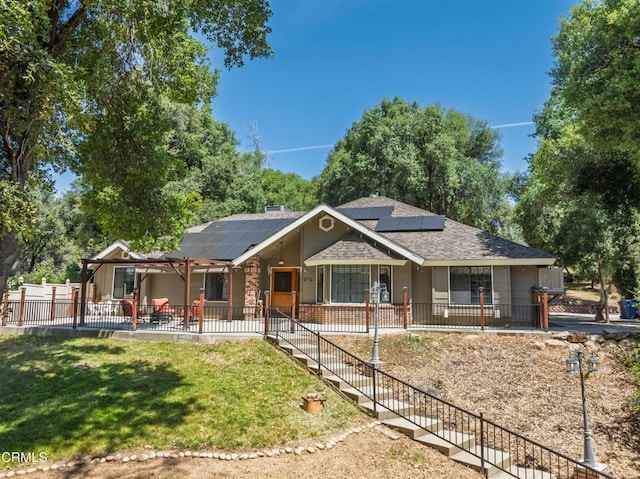 51793 Quail Ridge Rd, Oakhurst, CA 93644 - ranch-style home with roof mounted solar panels, a shingled roof, and a patio area