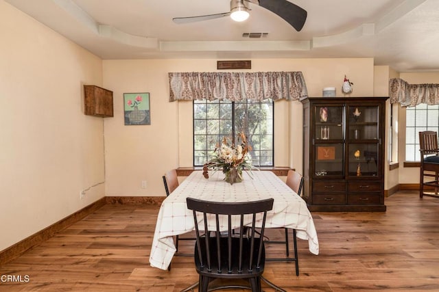 51793 Quail Ridge Rd, Oakhurst, CA 93644 - dining area with wood finished floors, healthy amount of natural light, a raised ceiling, and baseboards