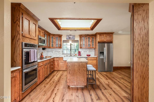 51793 Quail Ridge Rd, Oakhurst, CA 93644 - kitchen featuring stainless steel appliances, light wood-type flooring, light countertops, and brown cabinetry