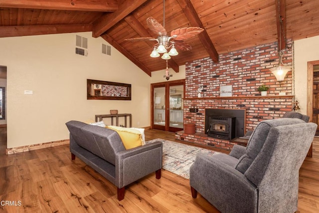 51793 Quail Ridge Rd, Oakhurst, CA 93644 - living area with a ceiling fan, wood ceiling with exposed beams, a wood stove, wood finished floors, and high vaulted ceiling