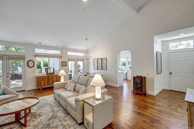 3372 Corsica Way, Oceanside, CA 92056 - living room with high vaulted ceiling, arched walkways, wood-type flooring, beamed ceiling, and a chandelier