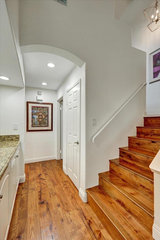 3372 Corsica Way, Oceanside, CA 92056 - stairway featuring arched walkways, wood-type flooring, recessed lighting, and a chandelier
