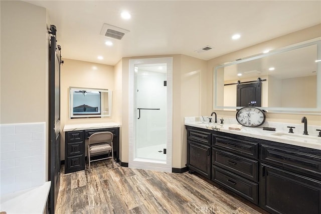 469 Grinnel Ct, Simi Valley, CA 93065 - bathroom featuring a stall shower, double vanity, wood finished floors, and recessed lighting