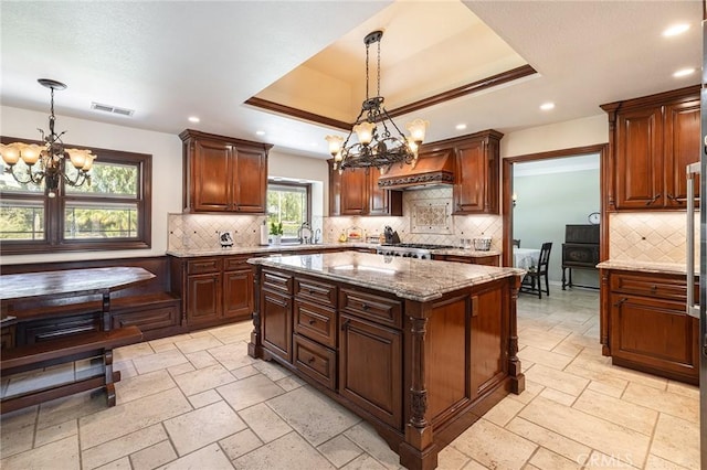 469 Grinnel Ct, Simi Valley, CA 93065 - kitchen with a chandelier, recessed lighting, a tray ceiling, decorative backsplash, and light stone counters