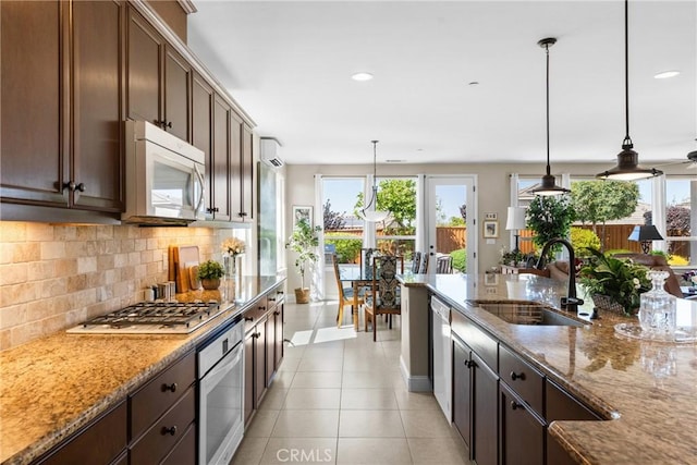 905 Romneya Ln, Santa Maria, CA 93455 - kitchen featuring a sink, white microwave, stainless steel oven, healthy amount of natural light, and recessed lighting