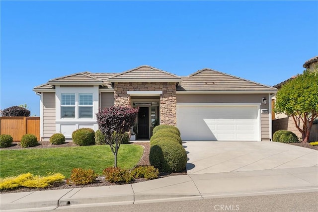 905 Romneya Ln, Santa Maria, CA 93455 - view of front of home featuring an attached garage, driveway, a tile roof, and stone siding